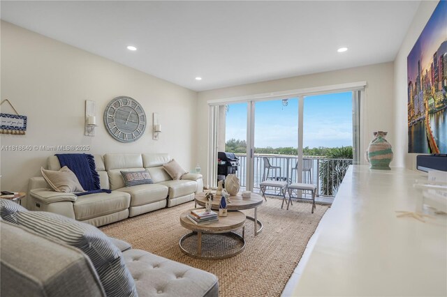 4034 N Ocean Dr, Hollywood, FL 33019 - kitchen with stainless steel appliances, blue cabinetry, a kitchen bar, recessed lighting, and white cabinets