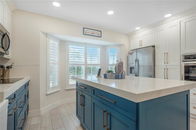 4034 N Ocean Dr, Hollywood, FL 33019 - kitchen featuring stainless steel oven, backsplash, a breakfast bar area, white cabinetry, and light stone counters