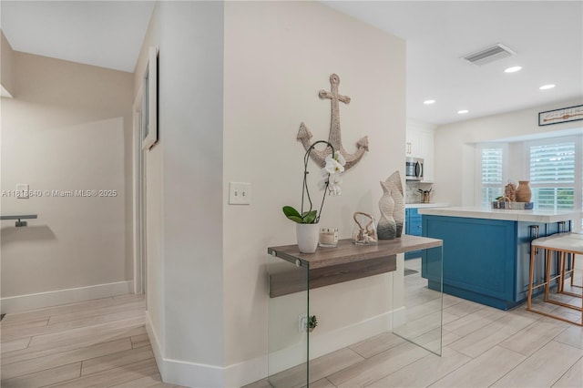 4034 N Ocean Dr, Hollywood, FL 33019 - hallway with wood tiled floors and recessed lighting