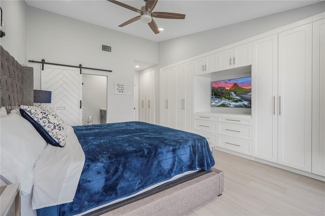 4034 N Ocean Dr, Hollywood, FL 33019 - bedroom with light wood-type flooring, a barn door, lofted ceiling, recessed lighting, and a ceiling fan