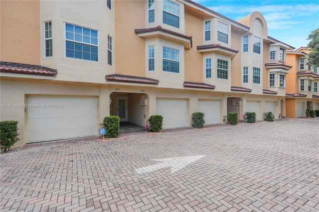 4034 N Ocean Dr, Hollywood, FL 33019 - multi unit property with an attached garage, stucco siding, driveway, and a residential view
