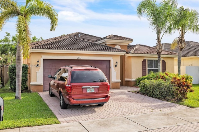 1951 NE 3rd Ct, Homestead, FL 33033 - view of front of house featuring stucco siding, decorative driveway, an attached garage, and a front lawn