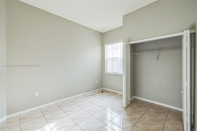 1951 NE 3rd Ct, Homestead, FL 33033 - unfurnished bedroom featuring a closet and light tile patterned flooring