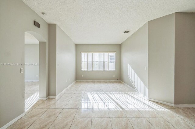1951 NE 3rd Ct, Homestead, FL 33033 - spare room with arched walkways and a textured ceiling