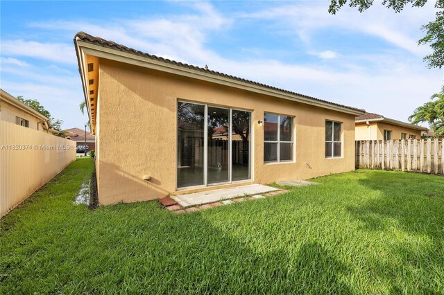 1951 NE 3rd Ct, Homestead, FL 33033 - rear view of property with stucco siding