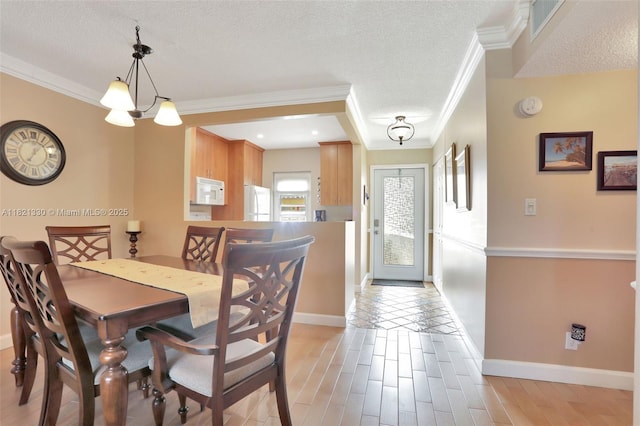 4311 NW 16th St Unit B103, Lauderhill, FL 33313 - dining space featuring a textured ceiling, ornamental molding, and light wood-type flooring