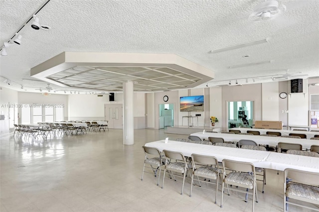 4311 NW 16th St Unit B103, Lauderhill, FL 33313 - dining area featuring rail lighting and a textured ceiling