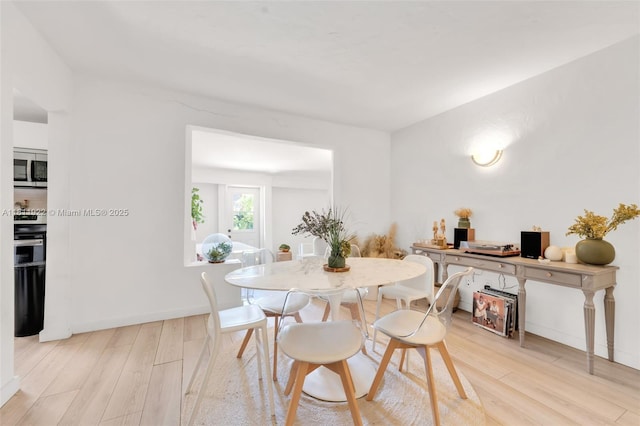 1339 14th Ter, Miami Beach, FL 33139 - dining space with light wood-type flooring and baseboards