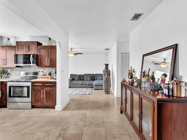 17320 SW 117th Ave, Miami, FL 33177 - kitchen featuring stainless steel appliances, a ceiling fan, tasteful backsplash, and open floor plan
