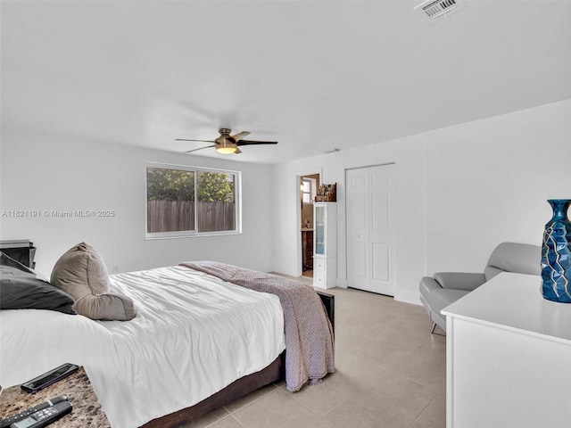 17320 SW 117th Ave, Miami, FL 33177 - bedroom featuring light tile patterned floors, a ceiling fan, a closet, and ensuite bathroom