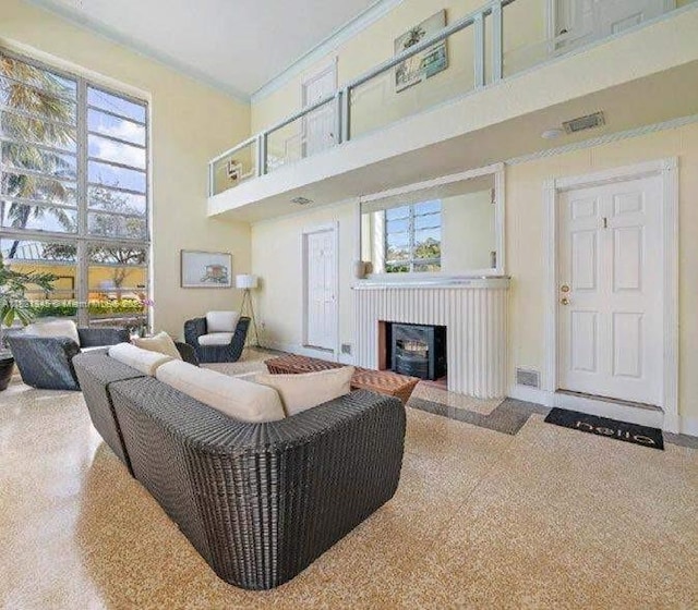 101 Lucerne Ave, Lake Worth, FL 33460 - living room with a towering ceiling, healthy amount of natural light, a fireplace, speckled floor, and ornamental molding
