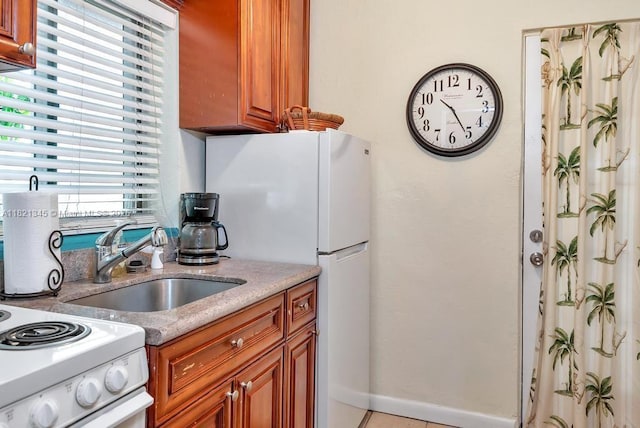101 Lucerne Ave, Lake Worth, FL 33460 - kitchen with white appliances, brown cabinetry, and light tile patterned flooring