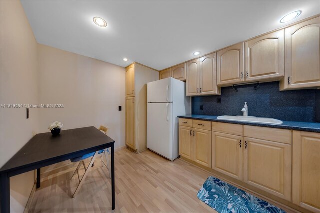 100 Bayview Dr Unit 1922, Sunny Isles Beach, FL 33160 - kitchen featuring freestanding refrigerator, light brown cabinets, backsplash, light wood finished floors, and dark countertops