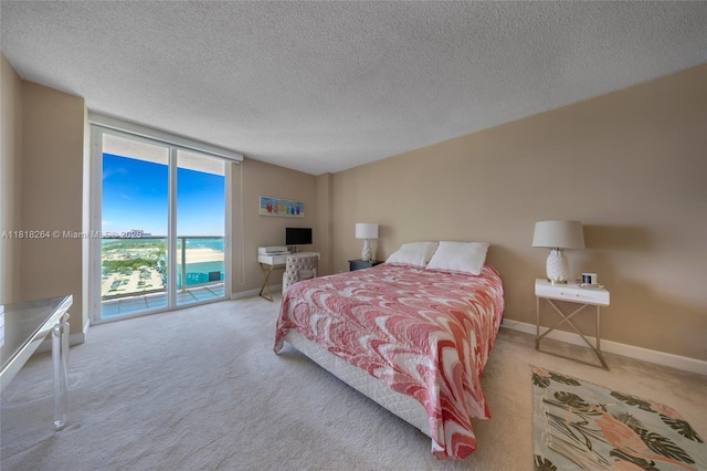 100 Bayview Dr Unit 1922, Sunny Isles Beach, FL 33160 - bedroom with access to outside, carpet floors, a textured ceiling, and a wall of windows