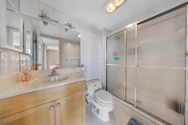 100 Bayview Dr Unit 1922, Sunny Isles Beach, FL 33160 - bathroom featuring tile walls, vanity, a stall shower, and tile patterned flooring