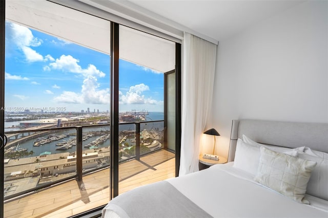 398 NE 5th St Unit 1809, Miami, FL 33132 - bedroom with floor to ceiling windows, a water view, wood finished floors, a city view, and view of marina