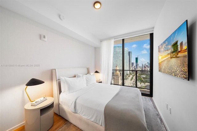 398 NE 5th St Unit 1809, Miami, FL 33132 - bedroom with baseboards and wood finished floors
