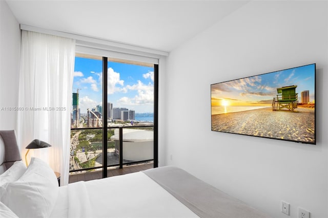 398 NE 5th St Unit 1809, Miami, FL 33132 - bedroom featuring floor to ceiling windows and wood finished floors