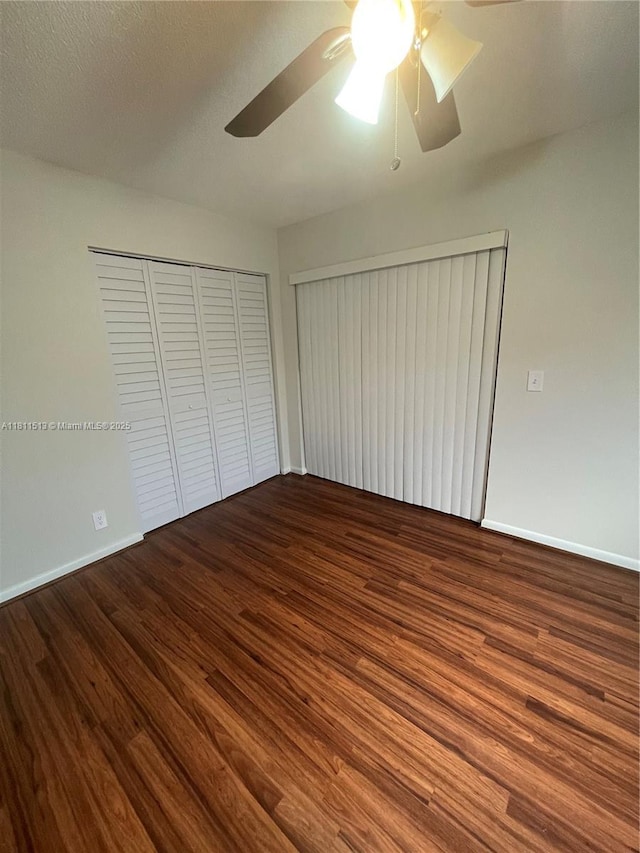 413 Saxony I Unit 413, Delray Beach, FL 33446 - unfurnished bedroom with wood finished floors, a closet, and a ceiling fan