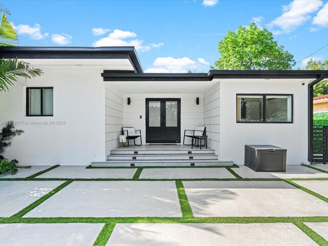 4531 SW 15th St, Miami, FL 33134 - entrance to property featuring french doors, a porch, and stucco siding