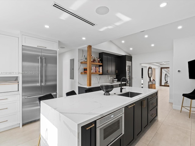 4531 SW 15th St, Miami, FL 33134 - kitchen with built in appliances, dark cabinets, a center island with sink, recessed lighting, and open shelves