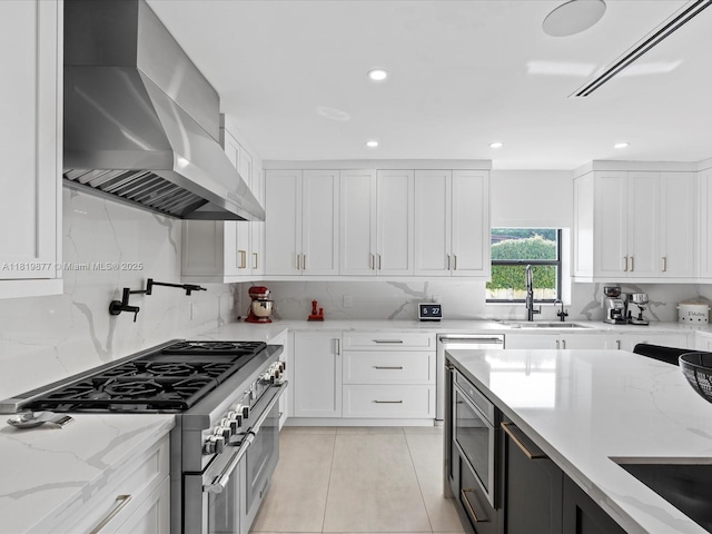 4531 SW 15th St, Miami, FL 33134 - kitchen with wall chimney exhaust hood, appliances with stainless steel finishes, tasteful backsplash, light tile patterned floors, and recessed lighting