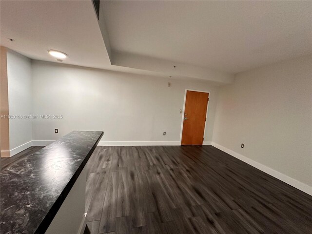 1542 Drexel Ave Unit 107, Miami Beach, FL 33139 - spare room featuring baseboards and dark wood-type flooring