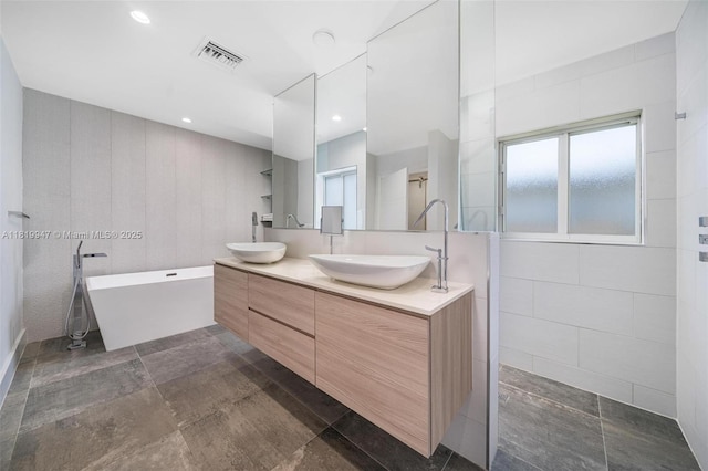7755 Noremac Ave, Miami Beach, FL 33141 - full bathroom with double vanity and a freestanding bath