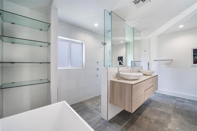 7755 Noremac Ave, Miami Beach, FL 33141 - full bath with a walk in shower, double vanity, a freestanding tub, recessed lighting, and stone finish floors