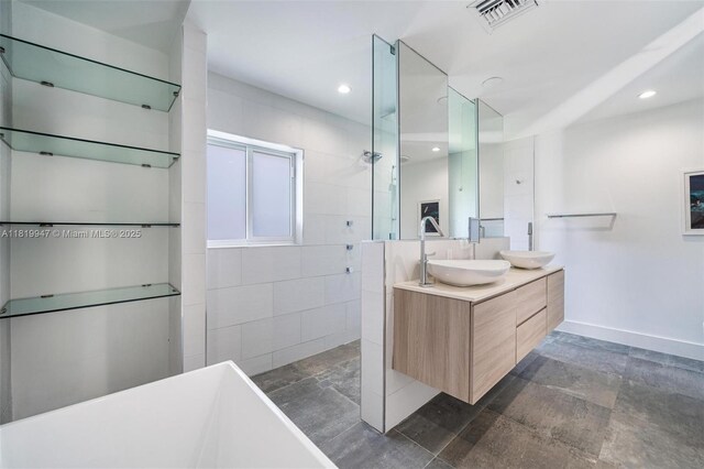 7755 Noremac Ave, Miami Beach, FL 33141 - bathroom featuring a walk in shower, double vanity, a soaking tub, and recessed lighting