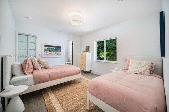 7755 Noremac Ave, Miami Beach, FL 33141 - bedroom with light wood-style floors, a closet, and connected bathroom