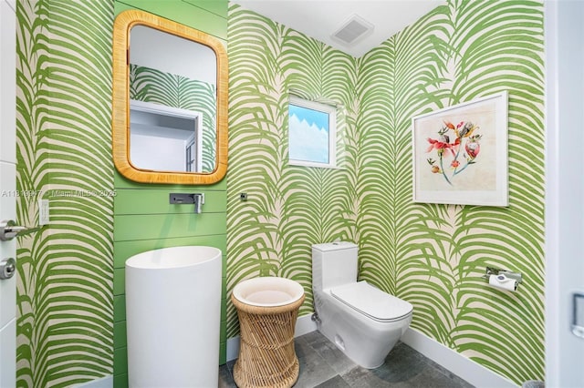 7755 Noremac Ave, Miami Beach, FL 33141 - bathroom with wallpapered walls and toilet