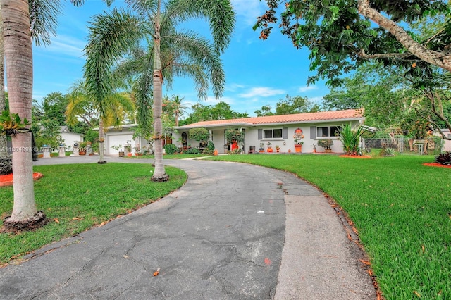 6285 Pine Ter, Plantation, FL 33317 - ranch-style house with curved driveway, stucco siding, and a garage