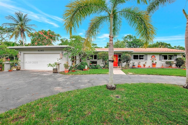 6285 Pine Ter, Plantation, FL 33317 - single story home featuring asphalt driveway, stucco siding, a front lawn, and a garage