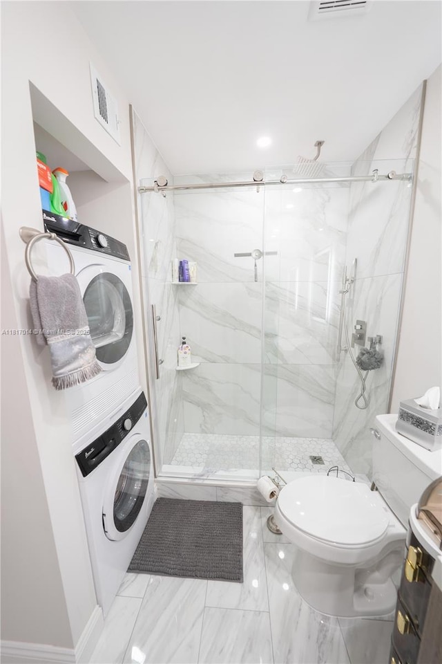 126 Piedmont C 126, Delray Beach, FL 33484 - full bath with stacked washer / drying machine and a marble finish shower