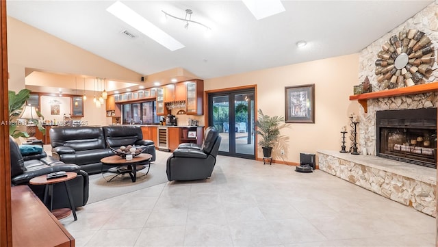 10123 Vestal Ct, Coral Springs, FL 33071 - living area featuring vaulted ceiling, beverage cooler, a skylight, a fireplace, and light tile patterned flooring
