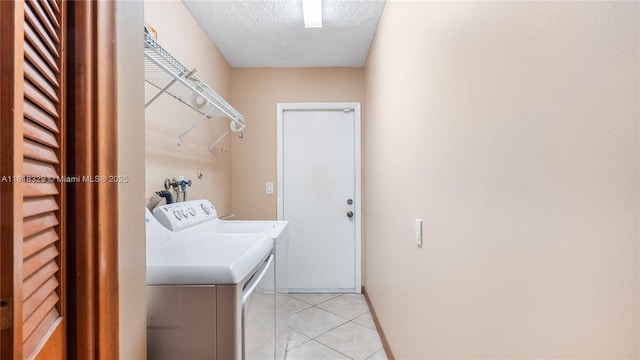 10123 Vestal Ct, Coral Springs, FL 33071 - washroom with independent washer and dryer, a textured ceiling, and light tile patterned floors
