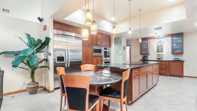 10123 Vestal Ct, Coral Springs, FL 33071 - kitchen featuring built in appliances, light tile patterned floors, glass insert cabinets, a kitchen island, and decorative light fixtures
