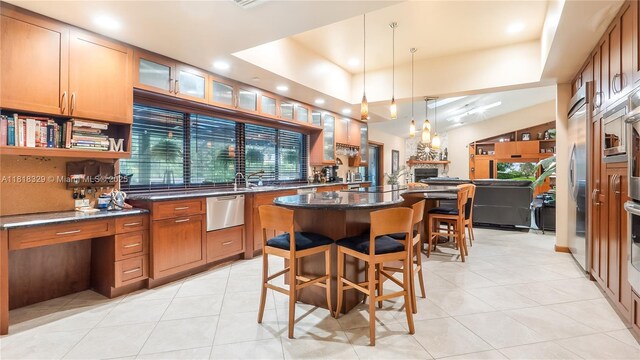 10123 Vestal Ct, Coral Springs, FL 33071 - kitchen with stainless steel appliances, a kitchen island, a breakfast bar area, light tile patterned floors, and recessed lighting