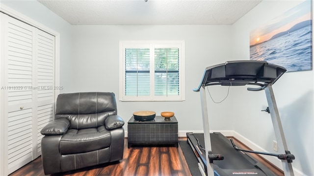 10123 Vestal Ct, Coral Springs, FL 33071 - exercise area featuring dark wood-style flooring and a textured ceiling