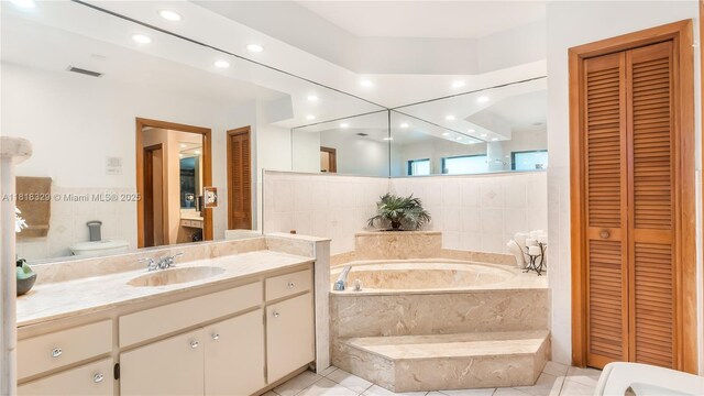 10123 Vestal Ct, Coral Springs, FL 33071 - bathroom with a closet, a bath, vanity, recessed lighting, and tile patterned floors