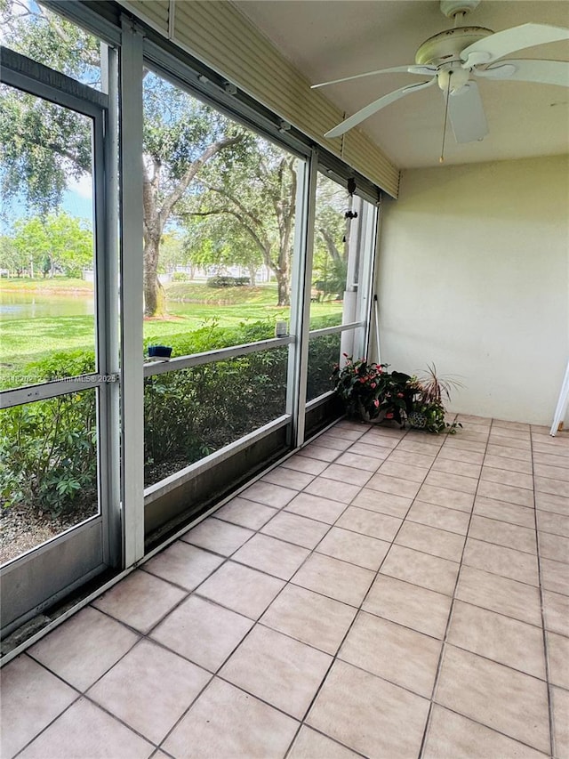 2304 Lucaya Ln Unit J1, Coconut Creek, FL 33066 - unfurnished sunroom featuring a ceiling fan and a water view
