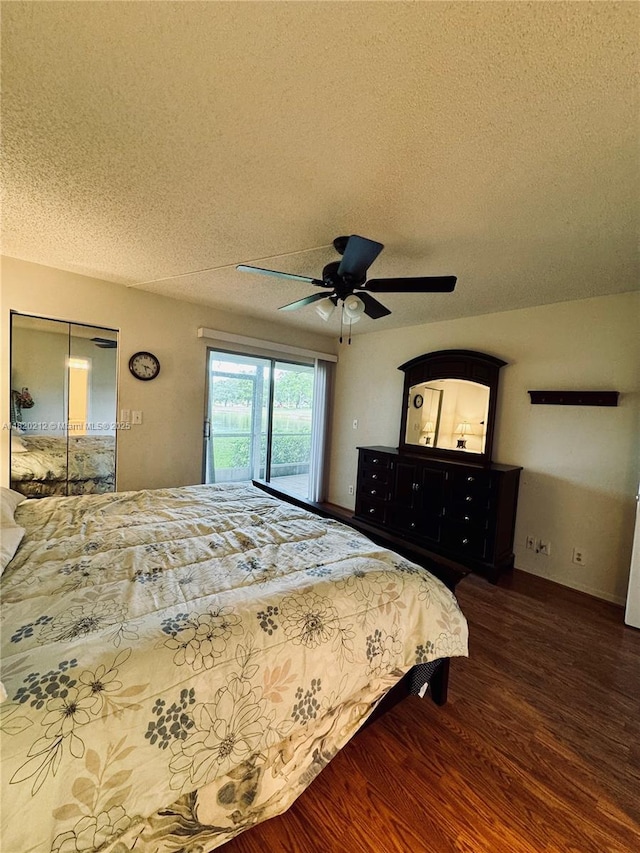 2304 Lucaya Ln Unit J1, Coconut Creek, FL 33066 - bedroom featuring a textured ceiling, wood finished floors, access to exterior, and ceiling fan