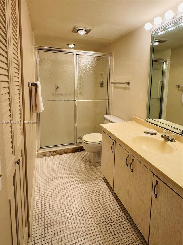 2304 Lucaya Ln Unit J1, Coconut Creek, FL 33066 - bathroom featuring vanity, a shower stall, and tile patterned floors