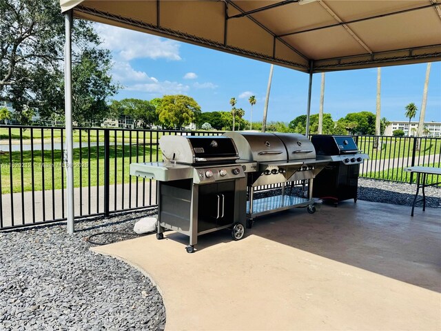 2304 Lucaya Ln Unit J1, Coconut Creek, FL 33066 - view of patio featuring a grill and a carport