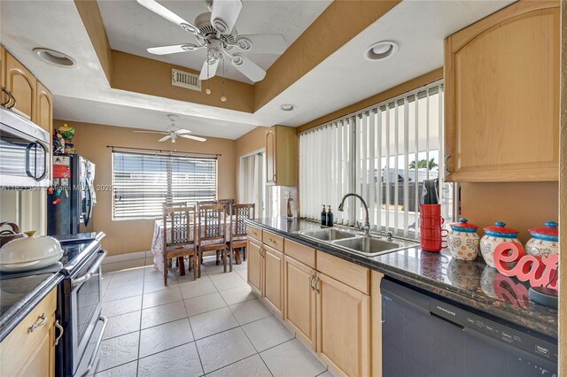 5340 SW 11th St, Margate, FL 33068 - kitchen with stainless steel appliances, light brown cabinetry, dark countertops, and a ceiling fan