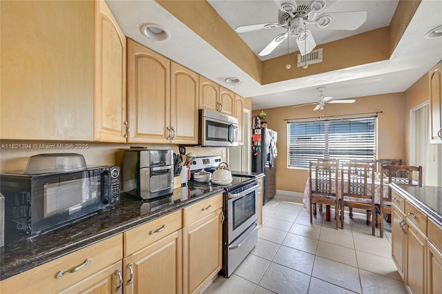 5340 SW 11th St, Margate, FL 33068 - kitchen featuring appliances with stainless steel finishes, a ceiling fan, light brown cabinetry, dark stone countertops, and light tile patterned flooring