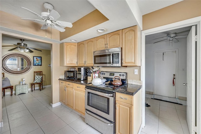 5340 SW 11th St, Margate, FL 33068 - kitchen with appliances with stainless steel finishes, light brown cabinets, ceiling fan, light tile patterned floors, and dark stone counters