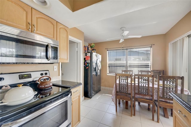 5340 SW 11th St, Margate, FL 33068 - kitchen with stainless steel appliances, light brown cabinets, a ceiling fan, light tile patterned flooring, and dark stone countertops
