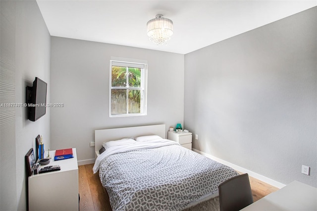 10857 NW 84th St, Doral, FL 33178 - bedroom with wood finished floors and a chandelier